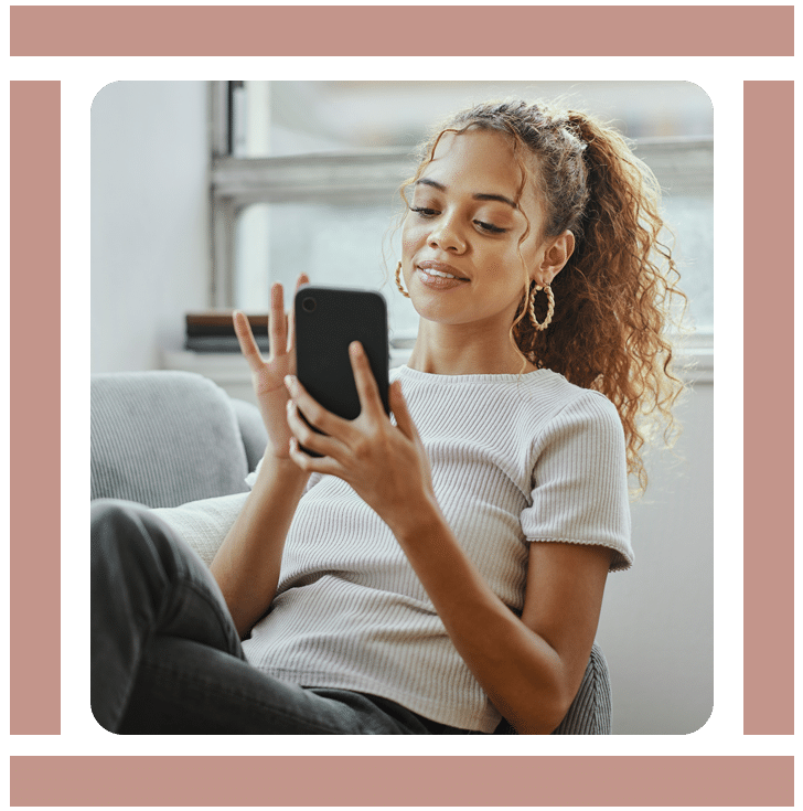 A young woman holding her phone