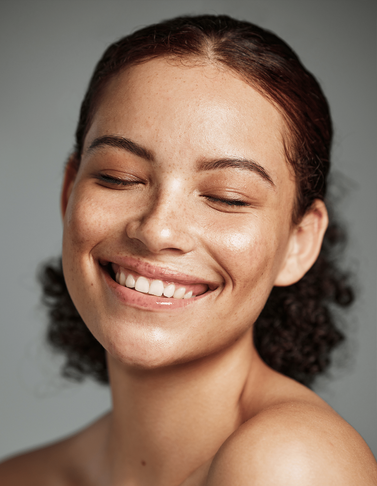 A happy young woman with smooth, clear skin